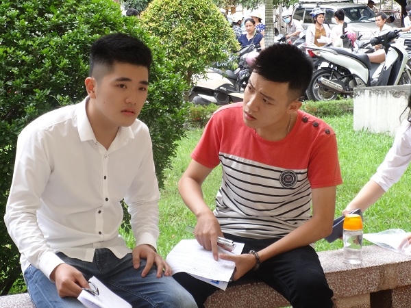 2 bạn nam vẫn cố gắng nán lại, trao đổi kết quả làm bài của mình.