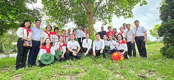 Những người làm Báo Pháp luật Việt Nam bên gốc cây bồ đề tại Ngã ba Đồng Lộc.