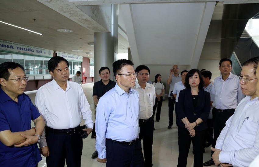 Phó Thủ tướng Lê Thành Long nghe Trưởng Ban quản lý Dự án báo cáo tình hình thi công Cơ sở 2 Bệnh viện Bạch Mai - Ảnh: VGP