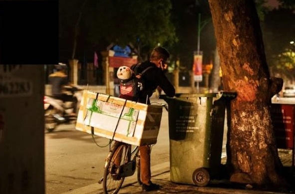 Hình ảnh ông bố cõng con nhặt rác mưu sinh trong đêm đầy thương cảm đã đánh lừa cộng đồng mạng xã hội.