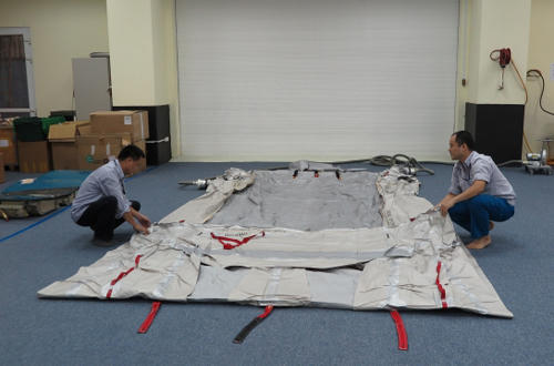 Nhân viên Công ty TNHH MTV Kỹ thuật máy bay (VAECO) đang cuộn lại túi khí máy bay.