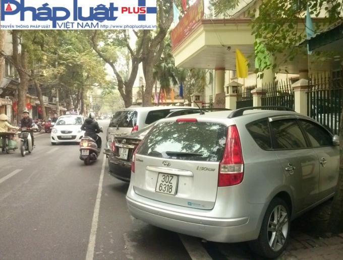 Một loạt xe ô tô đỗ chiếm trọn hết cả phần vỉa hè trước trụ sở Bộ Nội Vụ - 37 Nguyễn Bỉnh Khiêm.