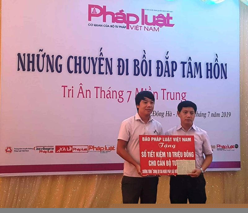 Phó Tổng biên tập Trần Đức Vinh tặng sổ tiết kiệm cho đại diện gia đình một cán bộ tư pháp ở TP Đông Hà