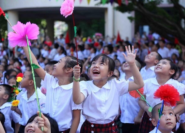 Niềm vui của các em học sinh lớp 1 trong ngày khai giảng năm học mới. (Ảnh: Quý Trung/TTXVN)