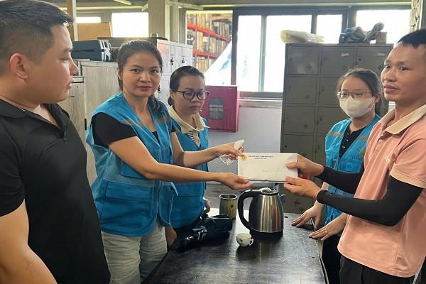 Chủ tịch Công đoàn Công ty TNHH Công nghiệp Lion Core Việt Nam, bà Đào Thị Thùy trao tiền ủng hộ đoàn viên có hoàn cảnh khó khăn.