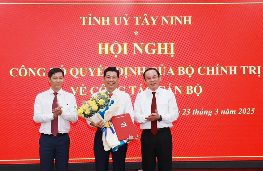 Uỷ viên Bộ Chính trị, Bí thư Thành uỷ Thành phố Hồ Chí Minh Nguyễn Văn Nên và Phó trưởng Ban Tổ chức Trung ương Nguyễn Thành Tâm trao quyết định, tặng hoa chúc mừng Bí thư Tỉnh uỷ Nguyễn Mạnh Hùng. Ảnh: Báo Tây Ninh
