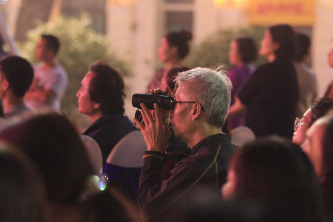 Một vị khách mang cả ống nhòm để theo dõi các tiết mục múa hát