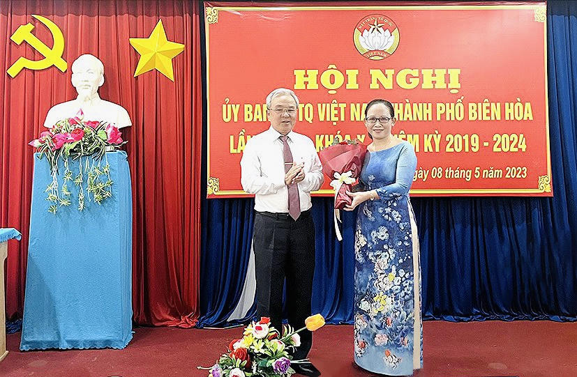 Ông Cao Văn Quang, Chủ tịch Ủy ban MTTQ Việt Nam tỉnh tặng hoa chúc mừng bà Thiều Thị Minh Hường. (Ảnh: Báo Đồng Nai)