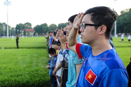 Mọi người d&acirc;n từ gi&agrave; đến trẻ đều nghi&ecirc;m trang hướng về cột cờ.&nbsp;