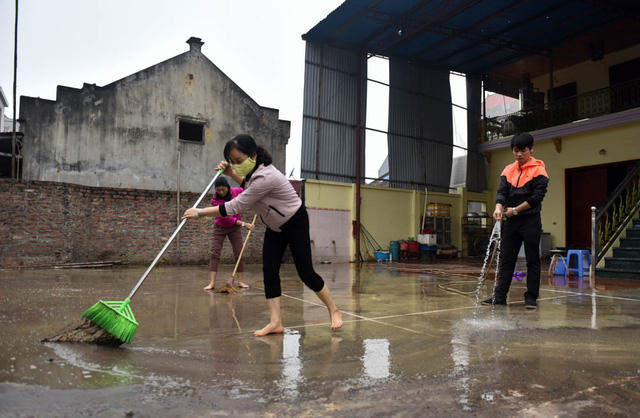 Vụ nổ khiến bùn đất, vật liệu bắn tung, rơi thành lớp dày khiến nhiều gia đình trong thôn phải xả nước quét dọn.