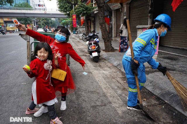 Bé gái lớn tên là Vũ Khánh Linh (8 tuổi, cao hơn, bên phải) và bé còn lại tên là Vũ Khánh Ly (5 tuổi, thấp hơn, bên trái) đang hớn hở, tạo dáng chụp ảnh trong ngày đầu năm mới. (Ảnh: Nguyễn Huy Tú).