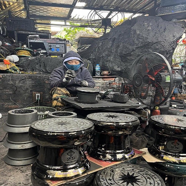 Chị Nguyễn Thị Thanh Bình tỉ mẩn điêu khắc cho sản phẩm làm bằng than đá.