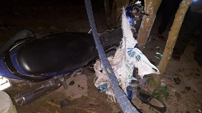 Chiếc xe máy của 2 đối tượng bị kẹt vào gốc cây. (Ảnh. Q.V)