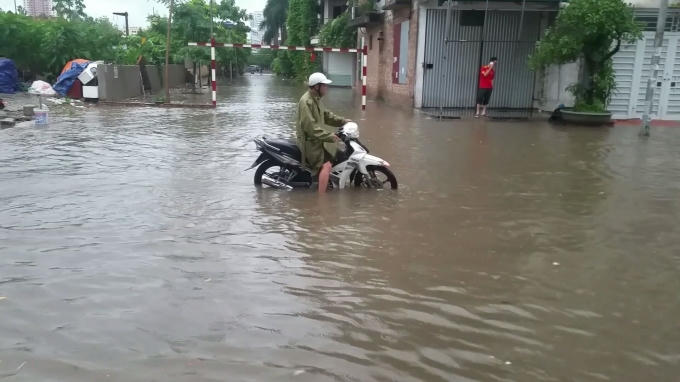 Tại đường Chiến Thắng (Hà Đông), nước ngập dâng cao đến quá vỉa hè làm các phương tiện khi di chuyển qua đây gặp nhiều khó khăn. Ảnh: Huy Trung