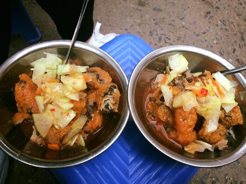 Bánh chín sẽ được cắt vào bát, cho thêm đu đủ xanh, ăn với nước mắm cay. Nhân bánh đậm đà, vỏ bánh giữ đươc độ giòn lâu. Quán ngày càng đông khách, chủ quán đã cử thêm người nhận đặt bánh qua điện thoại và giao hàng tận nơi để giảm thời gian đến quán chờ đợi. Quán mở từ trưa đến 7h tối, giá một chiếc là 7.000 đồng. Ảnh: Ngọc Linh