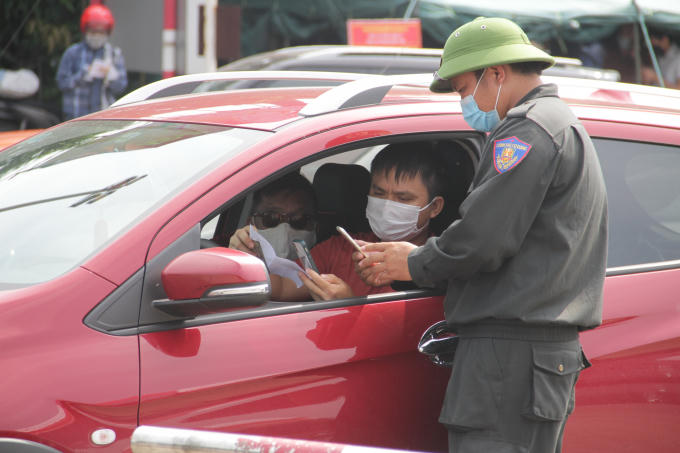 Lực lượng chức năng kiểm tra các giấy tờ cần thiết của người ra vào TP Vinh.