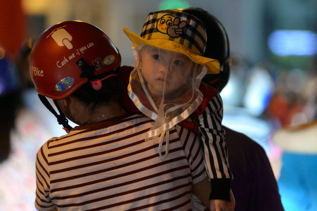 Em bé ngơ ngác khi bị vây trong biển xe cộ giữa trung tâm thành phố.