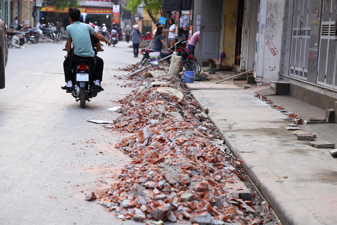 Phế liệu xây dựng tràn xuống lòng đường trên phố Hoàng Văn Thái.