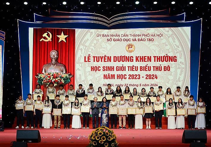 Phó Trưởng ban Dân vận Trung ương Phạm Tất Thắng và Phó Bí thư Thường trực Thành ủy Hà Nội Nguyễn Thị Tuyến trao hoa và bằng khen cho các học sinh tiêu biểu Thủ đô.