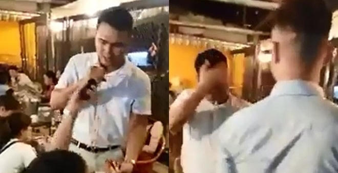 Ảnh cắt từ clip anh chàng hát rong bị hắt bia vào mặt.