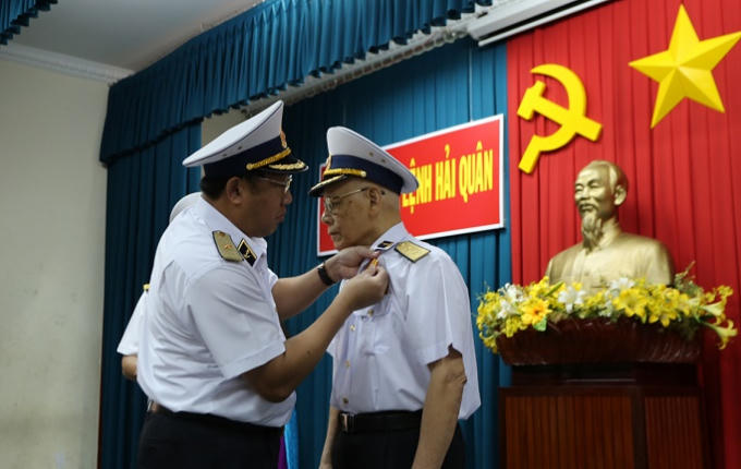 Thừa uỷ quyền của Chủ tịch nước, Chuẩn Đô đốc Phạm Hoài Nam, Ủy viên BCH Trung ương Đảng, Tư lệnh Hải quân gắn Huân chương Độc lập hạng Ba cho Phó Đô đốc Mai Xuân Vĩnh. Ảnh Duy Khánh