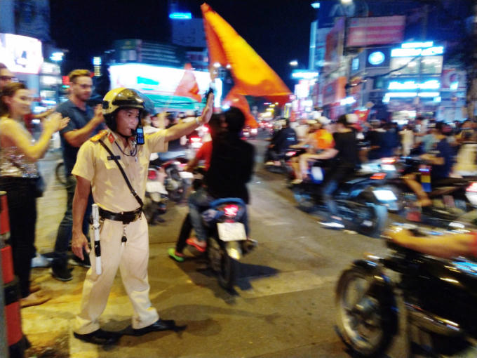 Lực lượng CSGT đứng chốt tại các nút giao thông để điều tiết, phân luồng cho CĐV "đi bão".