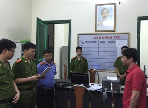 Cơ quan Điều tra đọc lệnh bắt tạm giam ông Trần Hiếu - Cán bộ Trung tâm Phát triển quỹ đất quận Hồng Bàng (bên phải).