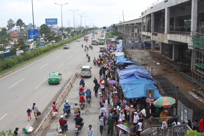 Người dân đứng chờ xe buýt.