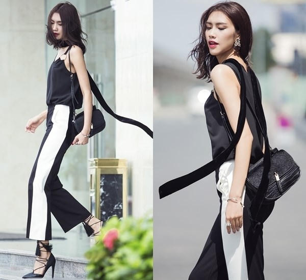 Quán quân Vietnam's Next Top Model 2014 ngày càng nhận được nhiều lời khen về street style bắt nhịp xu hướng. Xuống phố ngày nắng, cô chọn áo 2 dây phối cùng quần ống loe phối màu độc đáo. Nguyễn Oanh tạo điểm nhấn cho set đồ bằng khăn quàng bản mảnh và giày cao gót dây đan.