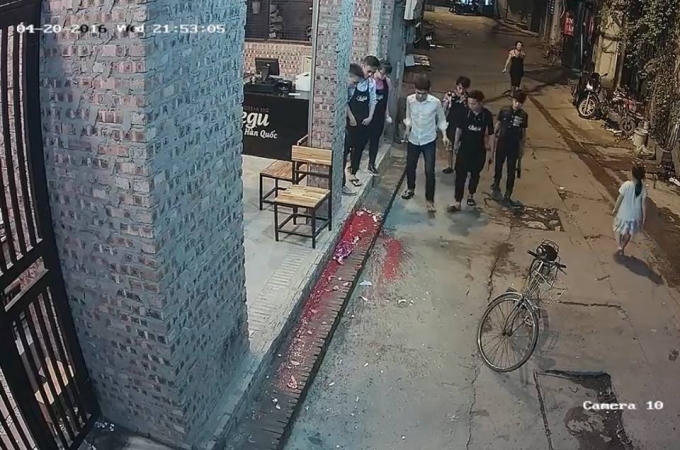 Chiếc phích chứa sơn và mắm tôm được ném xuống khu vực cửa quán khiến chất bẩn bên trong bắn tung tóe ra ngoài. (Ảnh: cắt từ clip).