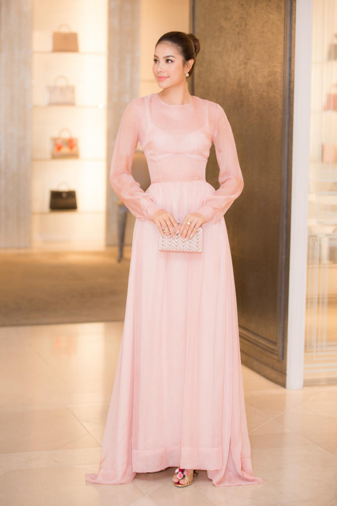 Hoa hậu Phạm Hương thử đôi bông tai và ví cầm tay.