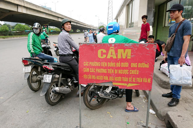 Các tài xế giả mạo lái xe GrabBike này thường không mặc đầy đủ đồng phục của công ty mà chỉ có áo hoặc mũ, không đi giày... Tại bến xe Mỹ Đình, những "tài xế GrabBike" này đứng tràn ra lòng đường để đón khách dù biển cấm đỗ xe ngay bên cạnh.