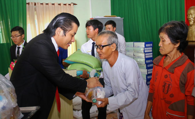Lãnh đạo Công ty CP An Gia Lập Nghiệp trao quà cho người nghèo.