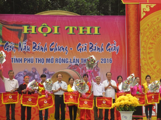 Ông Hà Kế San - Trưởng ban tổ chức lên trao cờ và hoa cho các đội tham gia gói, nấu bánh chưng. (Ảnh: Thu Hường)