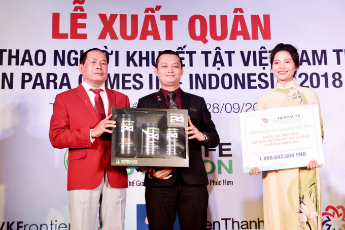 Ông Phạm Tường Huy, Tổng giám đốc Herbalife Việt Nam trao bảng tài trợ và sản phẩm dinh dưỡng tượng trưng cho Trưởng đoàn thể thao NKT Việt Nam tại lễ xuất quân