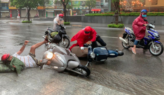 Người dân chạy xe đường Nguyễn Thiện Thuật, TP Nha Trang, bị gió quật ngã. Ảnh: VNE.