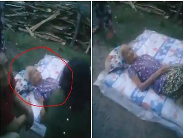 Cụ b&agrave; được đặt tr&ecirc;n tấm nệm v&agrave; vứt ra đường. Ảnh cắt từ clip