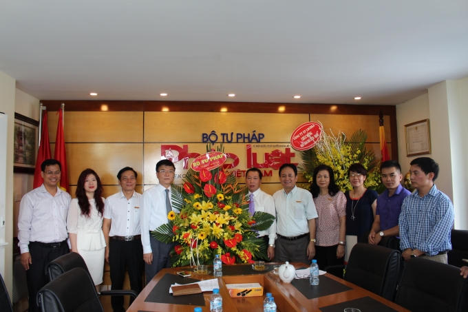 Bộ trưởng tặng hoa lãnh đạo, phóng viên Báo Pháp luật Việt Nam.