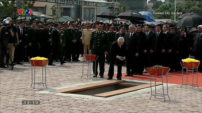 Các đồng chí lãnh đạo, nguyên lãnh đạo Đảng, Nhà nước và gia đình thả nắm đất đầu tiên xuống mộ nguyên Tổng Bí thư Đỗ Mười.