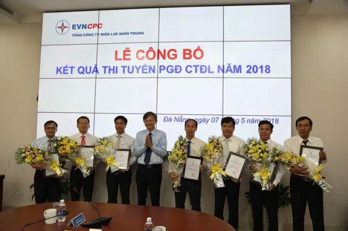 Ông Trần Đình Nhân - Chủ tịch kiêm Tổng giám đốc EVNCPC trao giấy chứng nhận trúng tuyển và tặng hoa chúc mừng cho 07 cá nhân