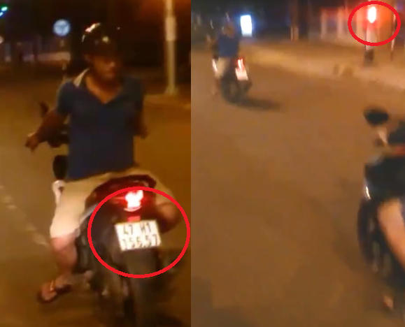 Nam thanh niên điều khiển xe quay lưng về phía trước, vượt đèn đỏ. (Ảnh: Cắt từ clip)
