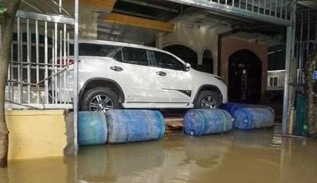 Chiếc SUV trọng lượng lớn nên phải dùng cả bè mảng tạo từ những chiếc thùng rỗng mới đủ nâng lên khỏi mặt nước
