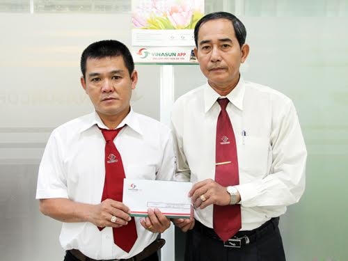 Ông Huỳnh Văn Sỹ - Phó Tổng GĐ Công ty Taxi Vinasun trao tiền thưởng cho tài xế Lương Hồng Phát.