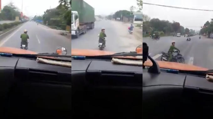 Hình ảnh Thiếu úy công an "đong đưa" trước đầu xe container.