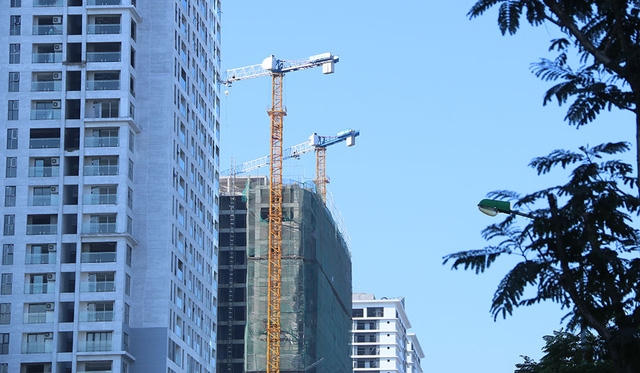 Cẩu tháp đang phục vụ cho một số công trình xây dựng dọc tuyến đường Lê Văn Lương.