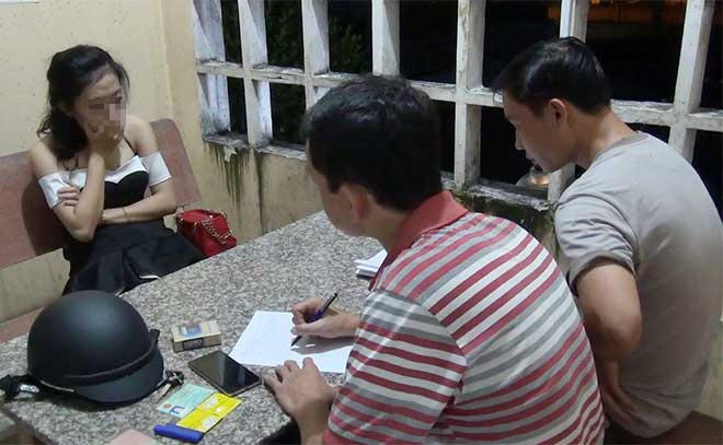 Lực lượng chức năng lấy lời khai của gái bán dâm. (Ảnh: báo Công an nhân dân)