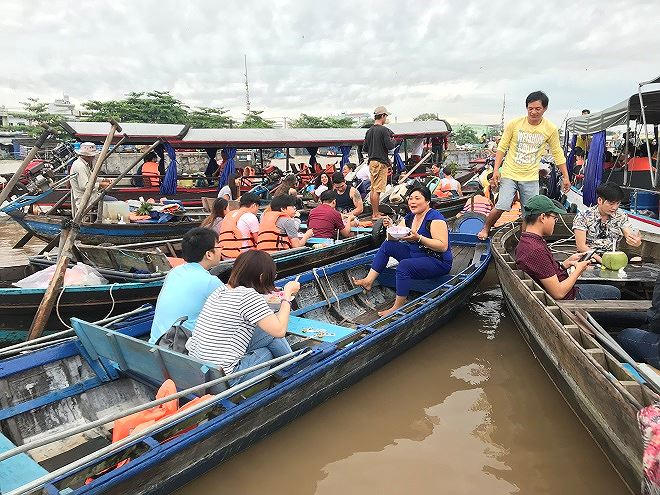 Khách du lịch ăn sáng trên những chiếc ghe được neo lại với nhau