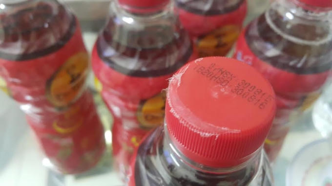 Vỏ ni-lon bọc ngoài lốc sản phẩm bị nóng chảy bám chặt vào nắp chai.