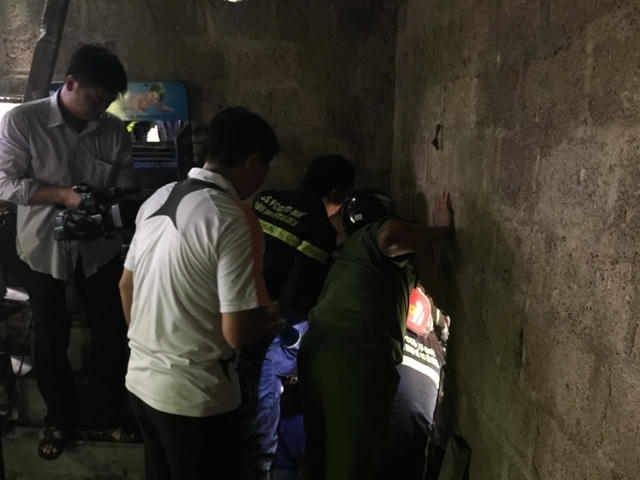 Lực lượng chức năng đang giải cứu người đàn ông bị mắc kẹt dưới cống.