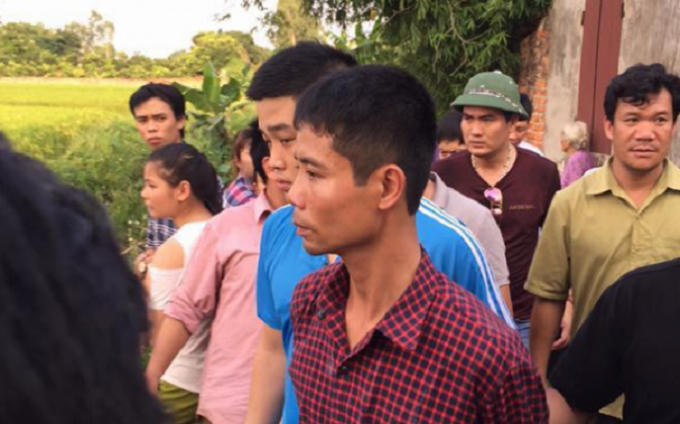 Nghi phạm Phan Văn Tuấn (áo kẻ sọc đỏ) bị lực lượng chức năng bắt giữ.
